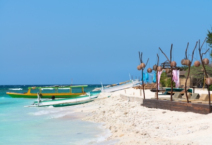 Small Wooden Long Boats On Blue Sea