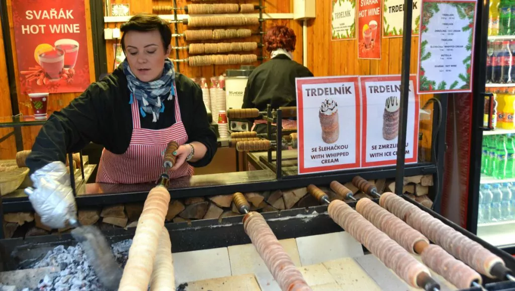 En kvinna tar hand om tillagningen av bakverket "trdelník"